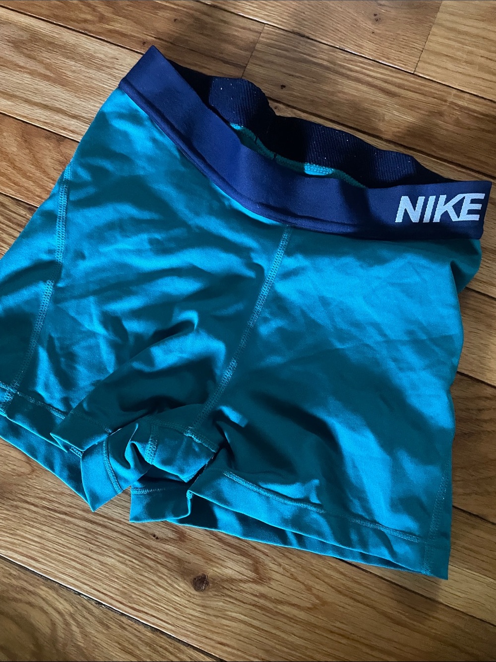 Nike Teal Compression Shorts with Navy Waistband and White Swoosh